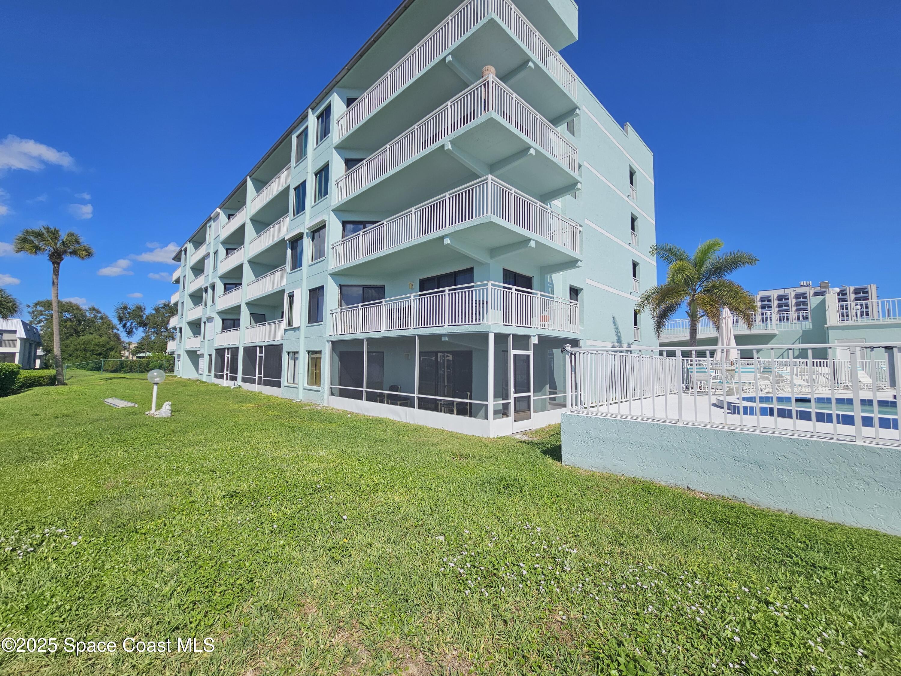 1750 Commodore Boulevard, Unit 2101 Cocoa Beach, FL 32931 - Photo 5 of 21 a view of building with garden