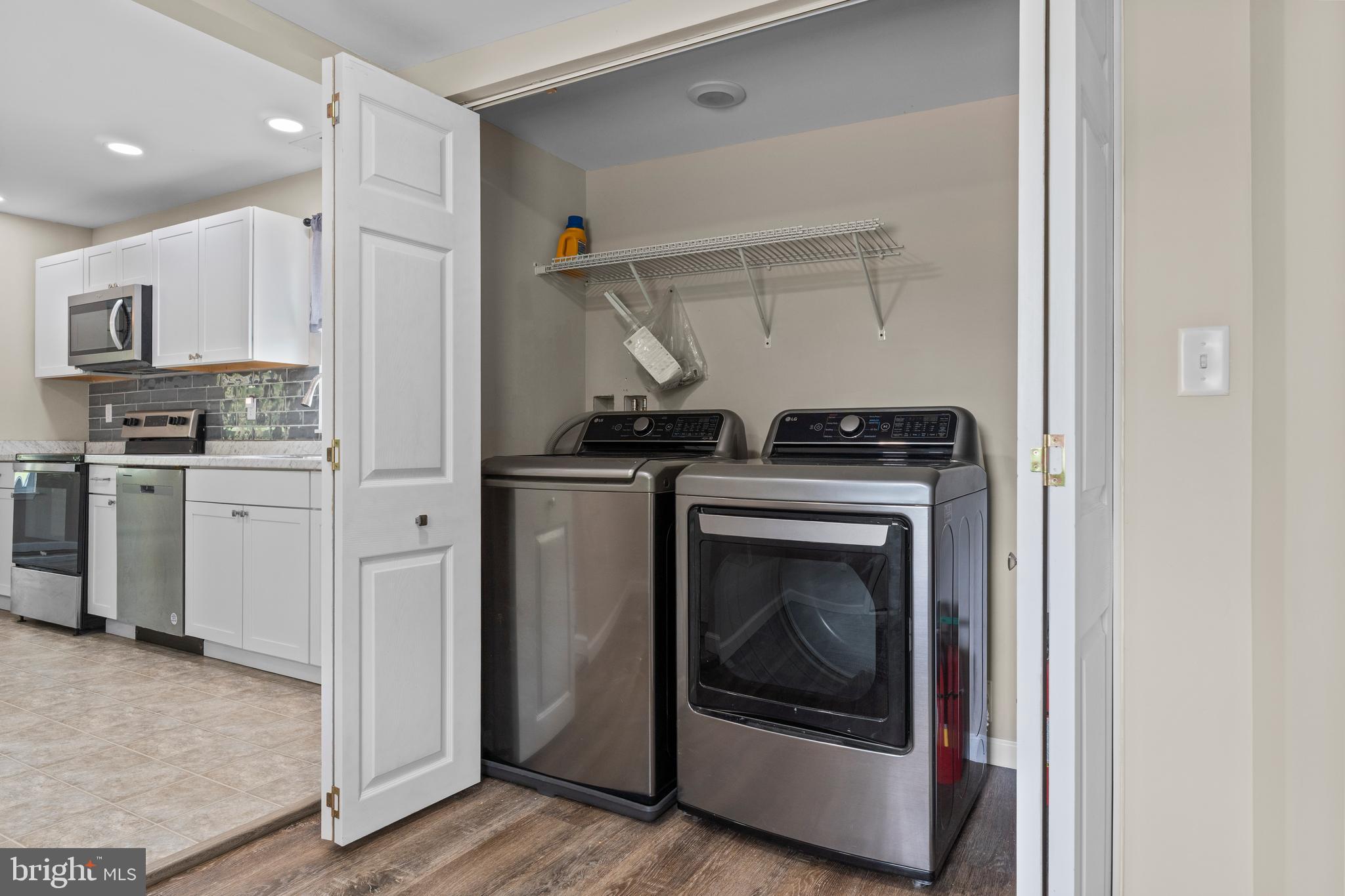 6475 Big Stone Beach Road Milford, DE 19963 - Photo 12 of 52 a kitchen with stainless steel appliances granite countertop a stove and a microwave