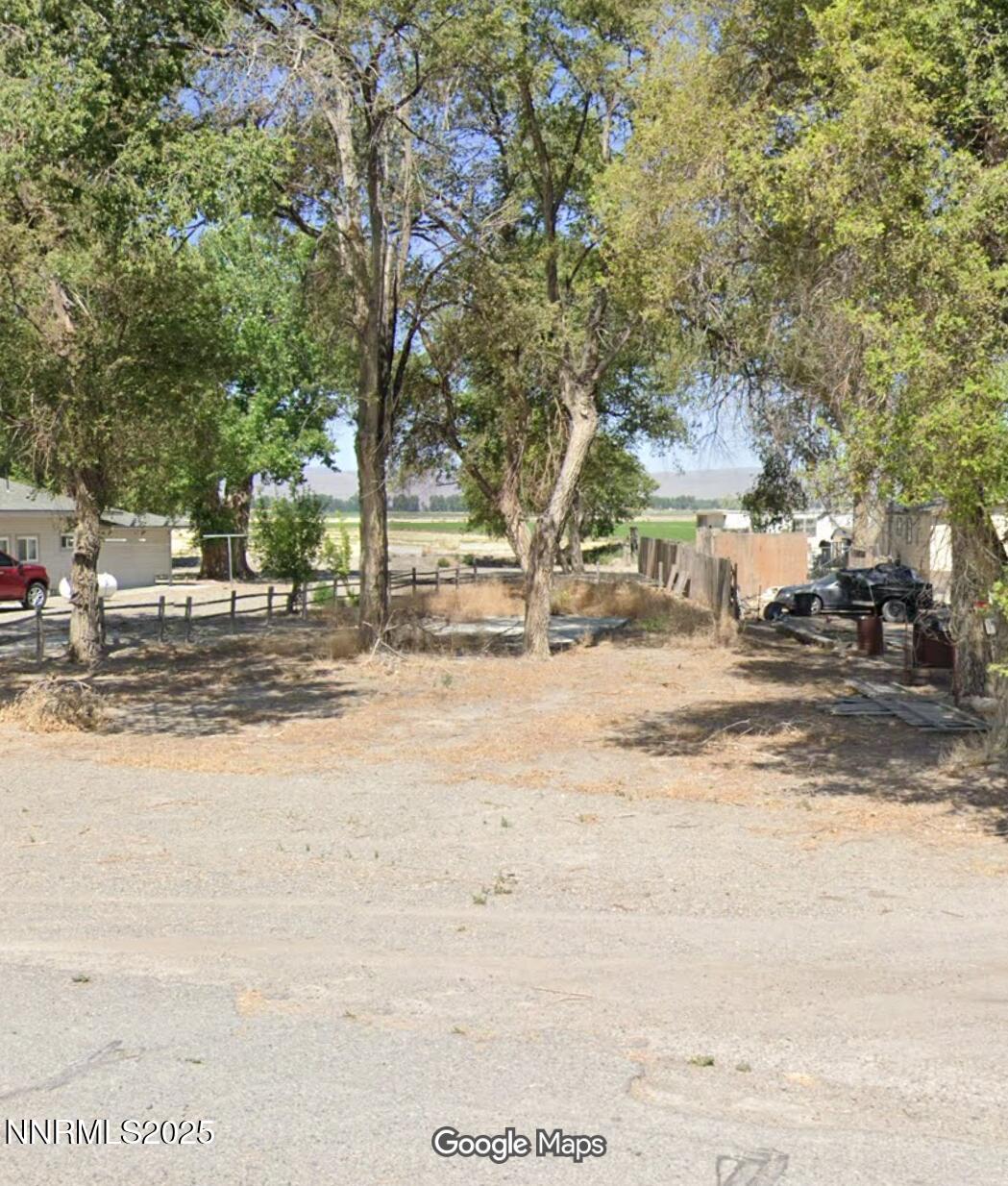 a view of road with large trees