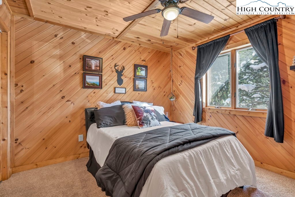 173 Spring Brook Road Newland, NC 28657 - Photo 19 of 39 a bed sitting in a bedroom next to a window