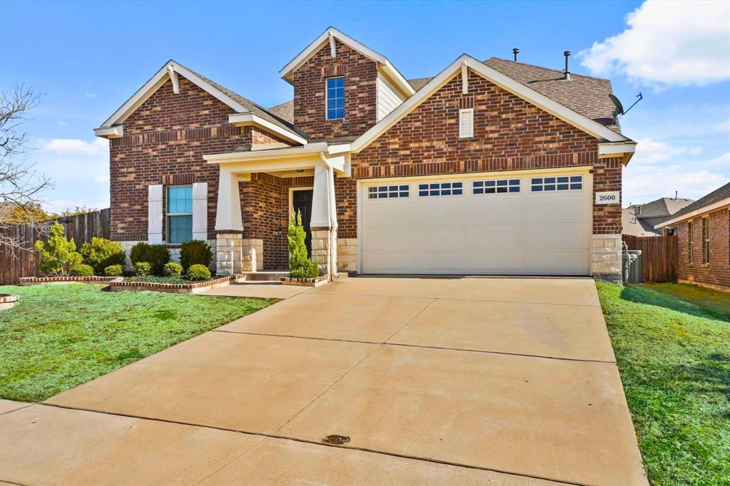 2600 Centurion Road Glenn Heights, TX 75154 - Photo 1 of 1 Craftsman inspired home featuring brick siding, a front lawn, fence, and a garage