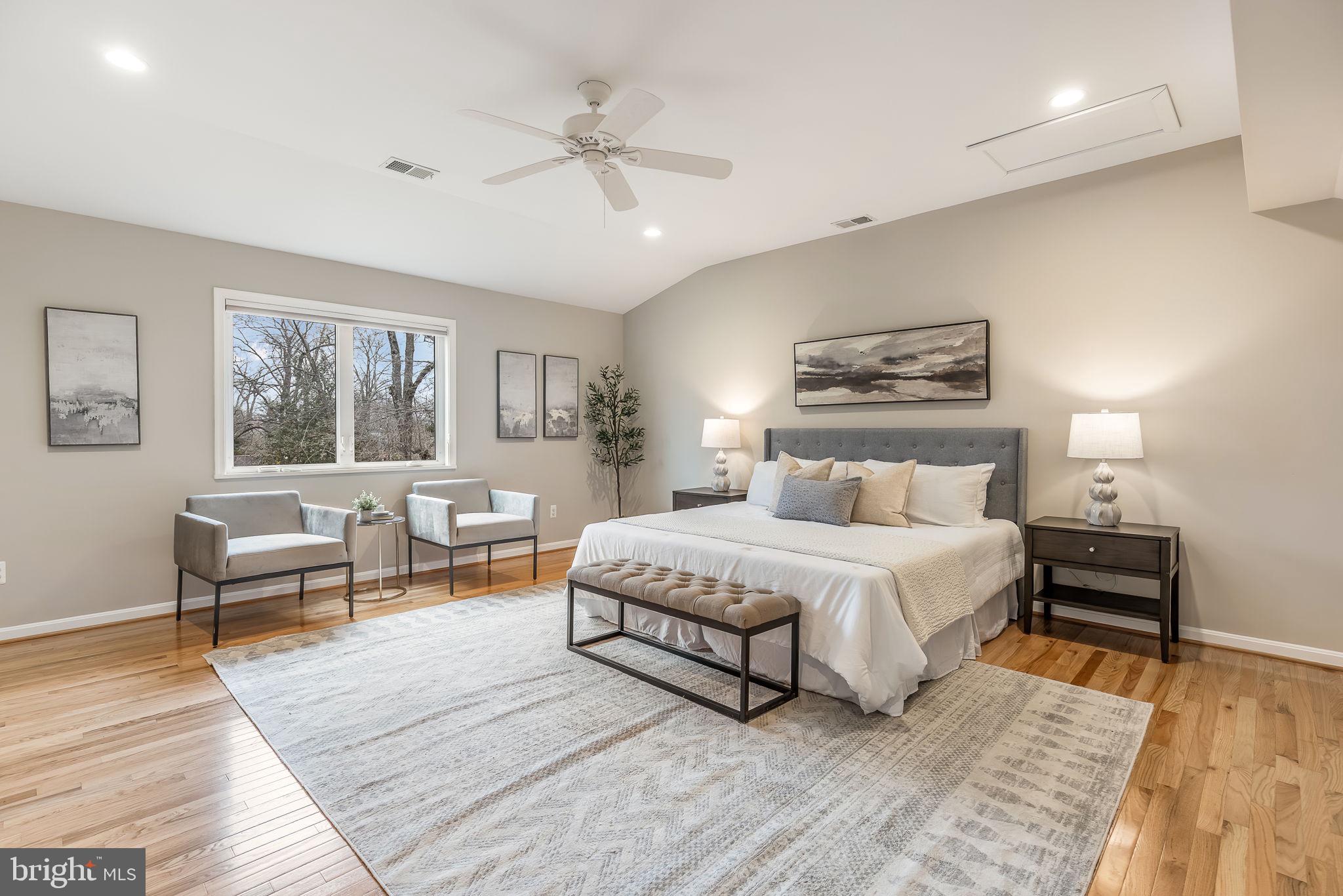 3103 Valley Lane Falls Church, VA 22044 - Photo 15 of 25 a spacious bedroom with a large bed a chandelier and windows
