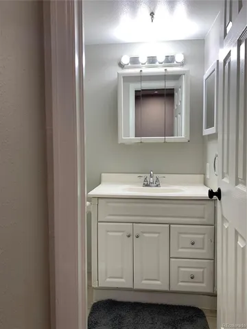 a bathroom with a sink a vanity and a mirror