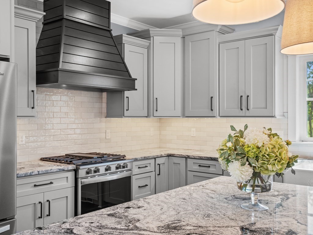 87 Brigham Hill Road Attleboro, MA 02703 - Photo 13 of 42 a kitchen with stainless steel appliances kitchen island wooden cabinets a sink and a stove