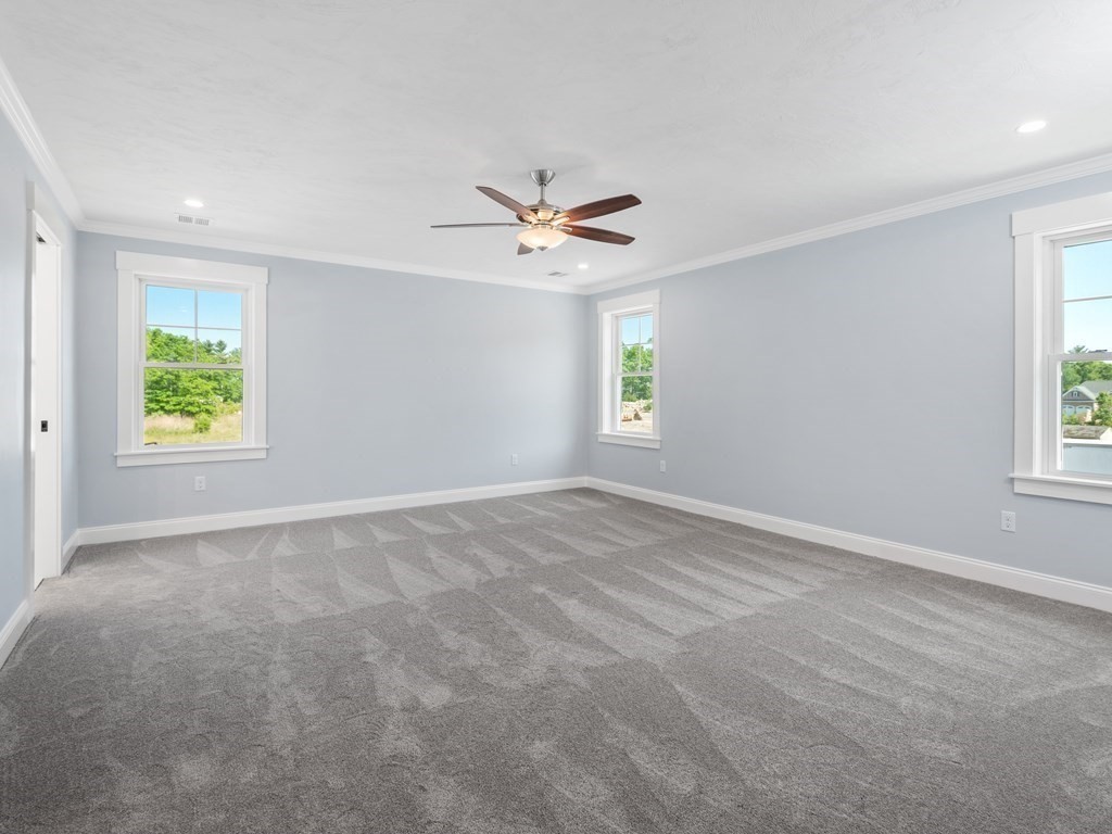 87 Brigham Hill Road Attleboro, MA 02703 - Photo 27 of 42 an empty room with windows and a ceiling fan
