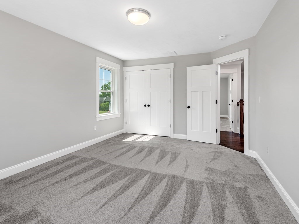 87 Brigham Hill Road Attleboro, MA 02703 - Photo 36 of 42 a view of an empty room with wooden floor and a window