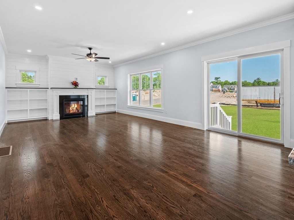 87 Brigham Hill Road Attleboro, MA 02703 - Photo 8 of 42 an empty room with wooden floor fireplace and windows