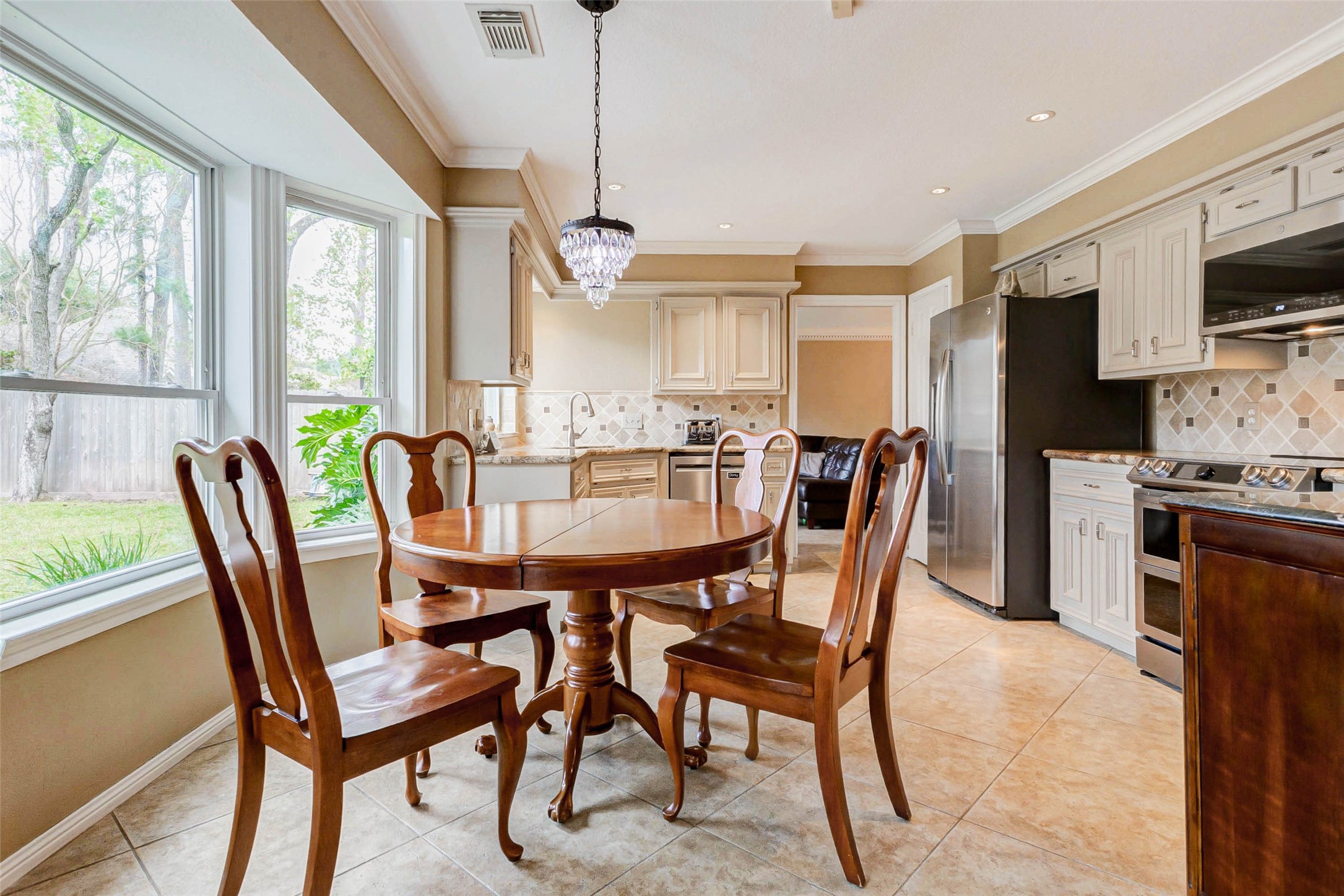 15811 Spring Forest Drive Houston, TX 77059 - Photo 8 of 27 This inviting breakfast nook, bathed in natural light from expansive windows overlooking a lush garden, offers the perfect spot for cozy morning meals in a beautifully appointed kitchen.