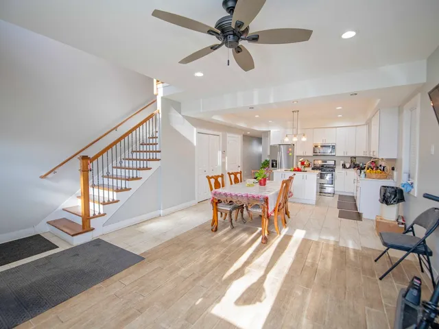 a dining room with furniture entryway and wooden floor
