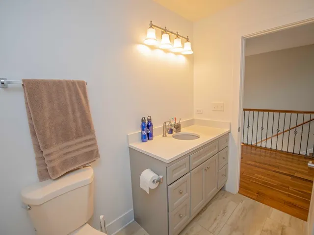 a bathroom with a sink a toilet and mirror