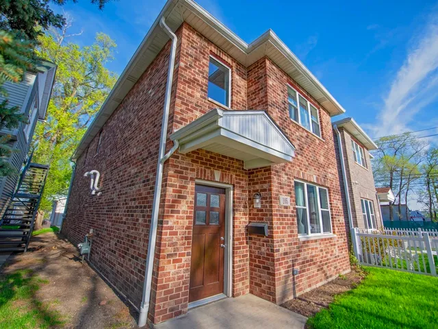 a view of a brick building with many windows