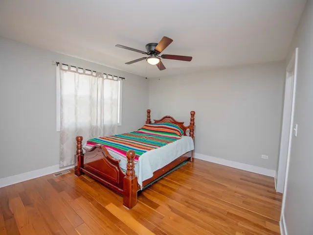 a room with a bed and a chandelier