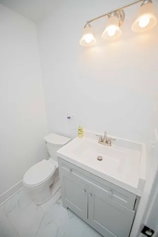 a bathroom with a sink a toilet and a mirror