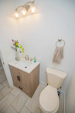 a bathroom with a sink toilet and a mirror