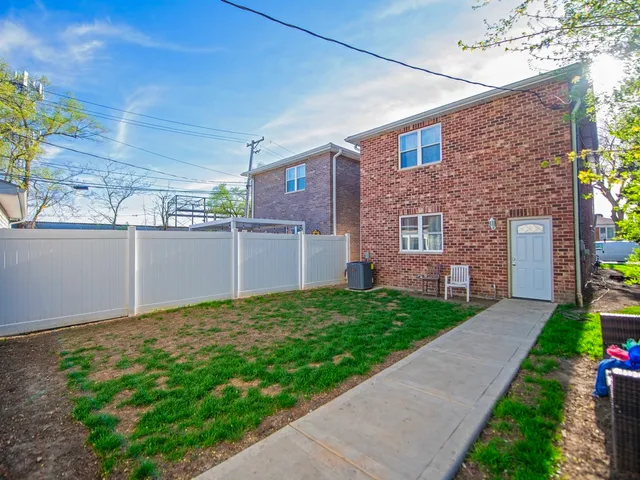a view of a brick house with a yard