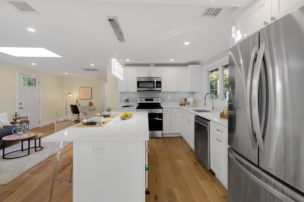 15 Red Acre Road Stow, MA 01775 - Photo 11 of 42 a kitchen with refrigerator a microwave and furniture