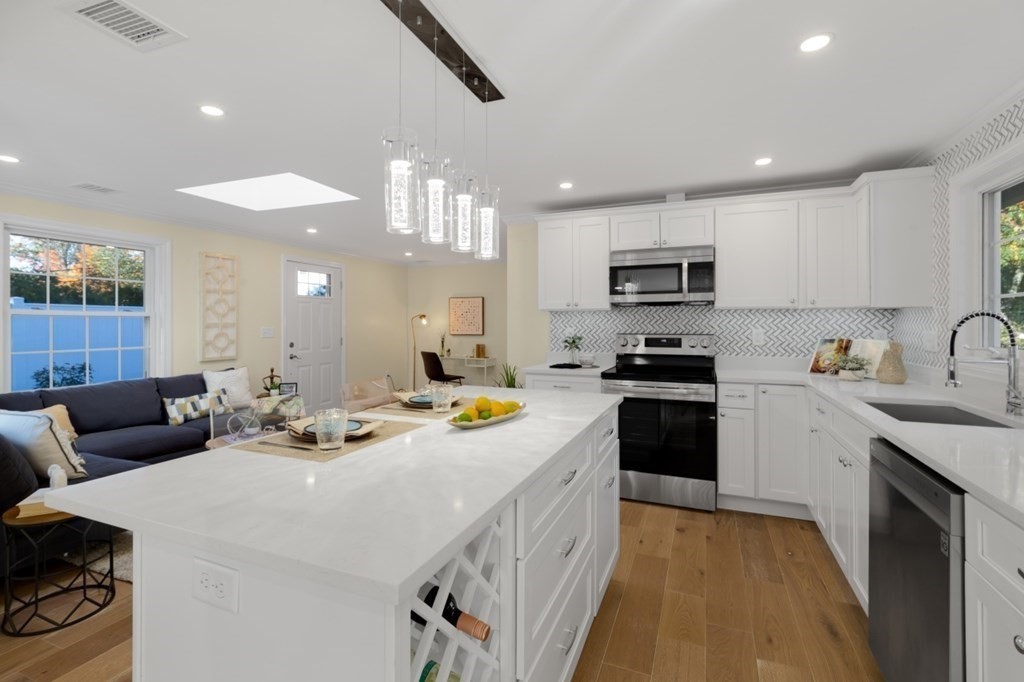 15 Red Acre Road Stow, MA 01775 - Photo 13 of 42 a kitchen with a sink a stove and cabinets