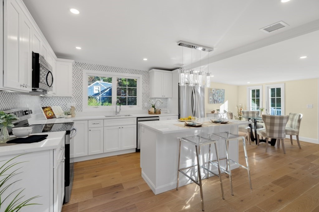 15 Red Acre Road Stow, MA 01775 - Photo 14 of 42 a kitchen with cabinets and chairs