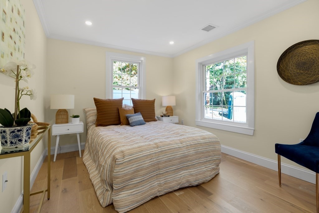 15 Red Acre Road Stow, MA 01775 - Photo 21 of 42 a bedroom with a bed a dresser and a window