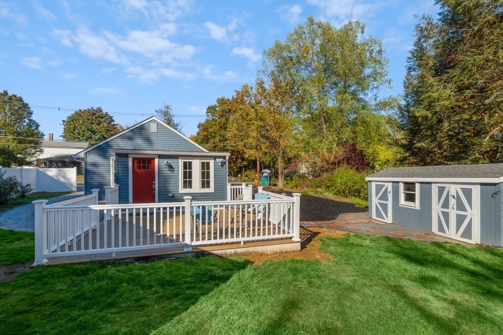 15 Red Acre Road Stow, MA 01775 - Photo 27 of 42 a view of a house with a deck and a yard