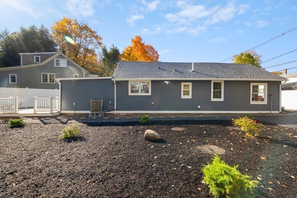 15 Red Acre Road Stow, MA 01775 - Photo 32 of 42 a backyard of a house with potted plants and large tree