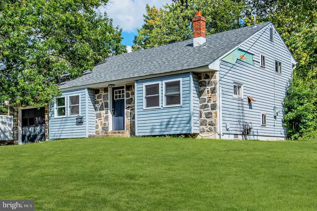 a front view of house with a garden