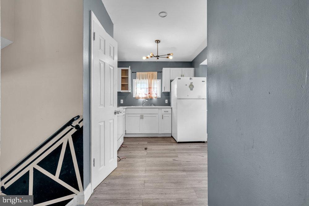 211 Chatham Drive Lindenwold, NJ 08021 - Photo 12 of 42 a view of a kitchen with a sink and dishwasher a refrigerator with wooden floor