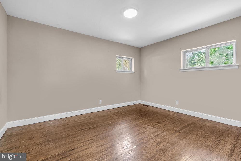 211 Chatham Drive Lindenwold, NJ 08021 - Photo 21 of 42 a view of an empty room with wooden floor and window