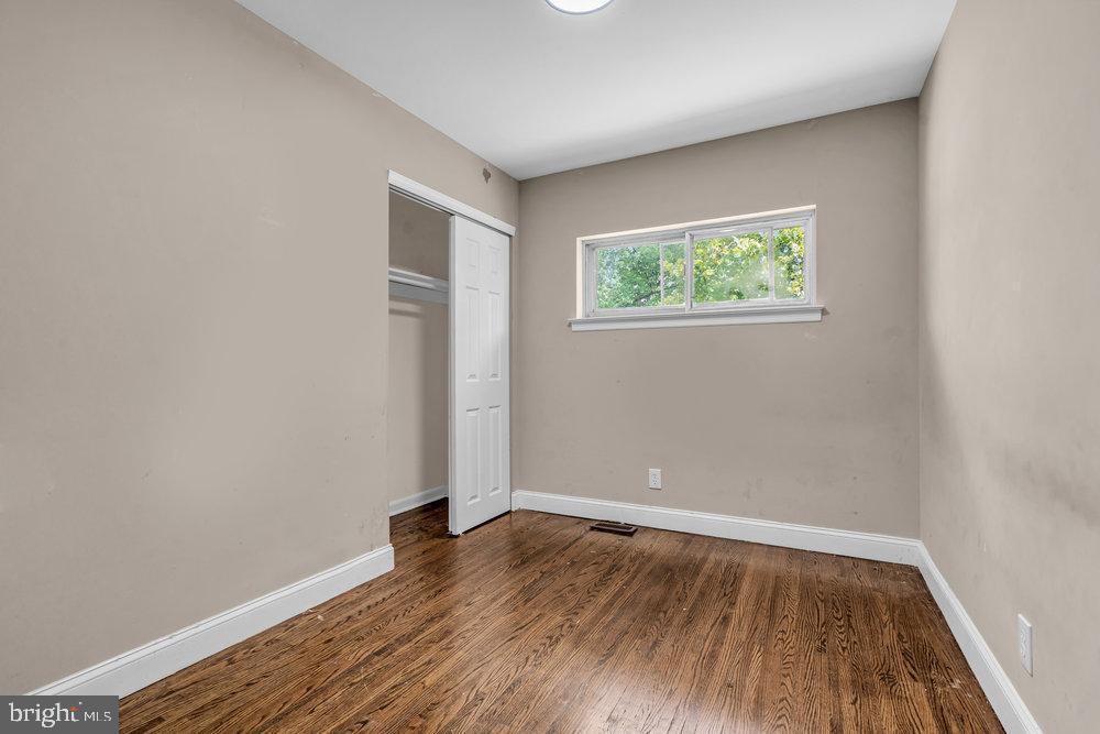 211 Chatham Drive Lindenwold, NJ 08021 - Photo 23 of 42 a view of an empty room with wooden floor and a window