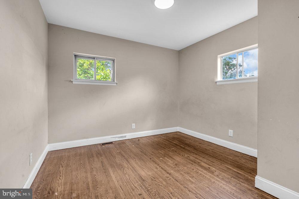 211 Chatham Drive Lindenwold, NJ 08021 - Photo 25 of 42 a view of an empty room with wooden floor and a window