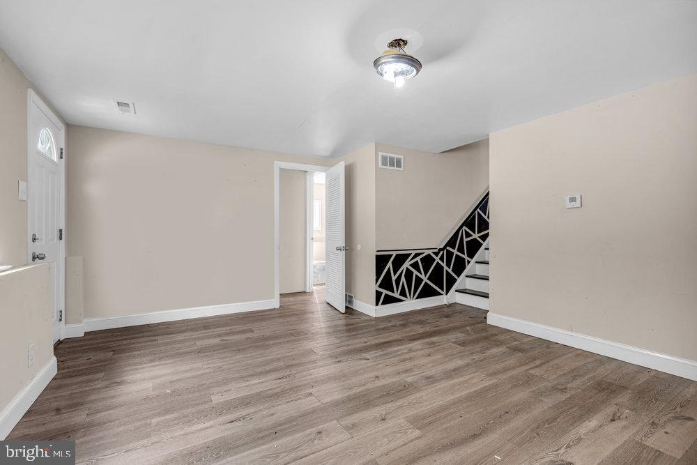 211 Chatham Drive Lindenwold, NJ 08021 - Photo 31 of 42 a view of an empty room with wooden floor and stairs