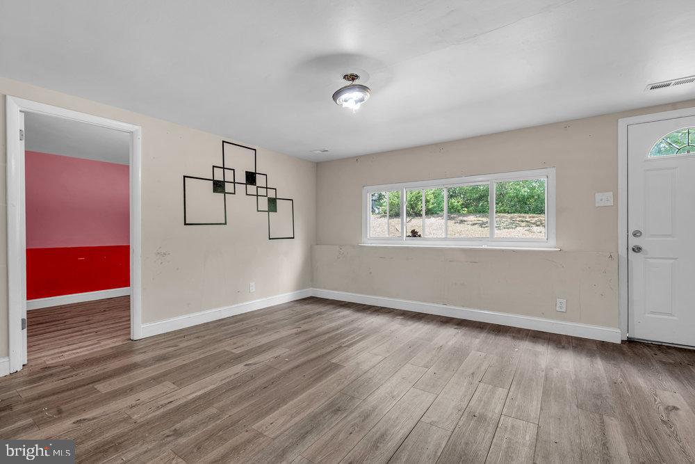 211 Chatham Drive Lindenwold, NJ 08021 - Photo 32 of 42 a view of empty room with wooden floor and window
