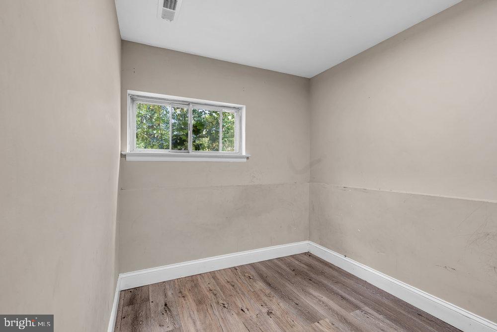 211 Chatham Drive Lindenwold, NJ 08021 - Photo 34 of 42 a view of an empty room with wooden floor and a window