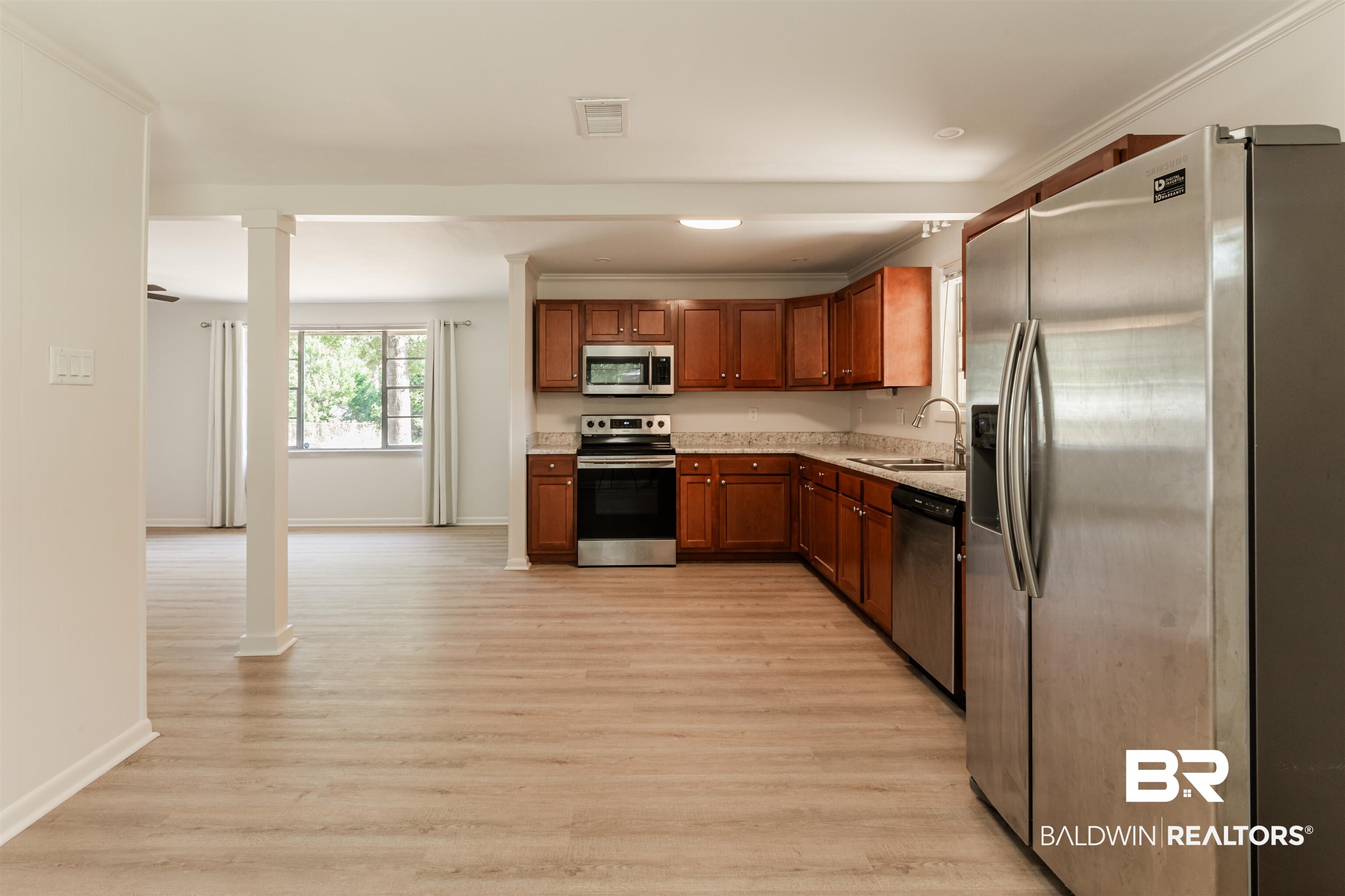 3970 Oak Ridge Avenue Mobile, AL 36619 - Photo 8 of 28 Kitchen with light hardwood / wood-style flooring, ornamental molding, stainless steel appliances, and sink