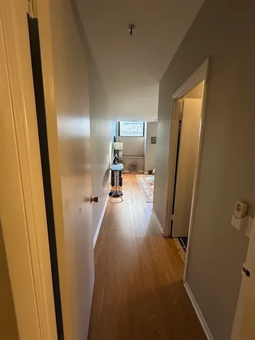 a view of a hallway with a wooden floor