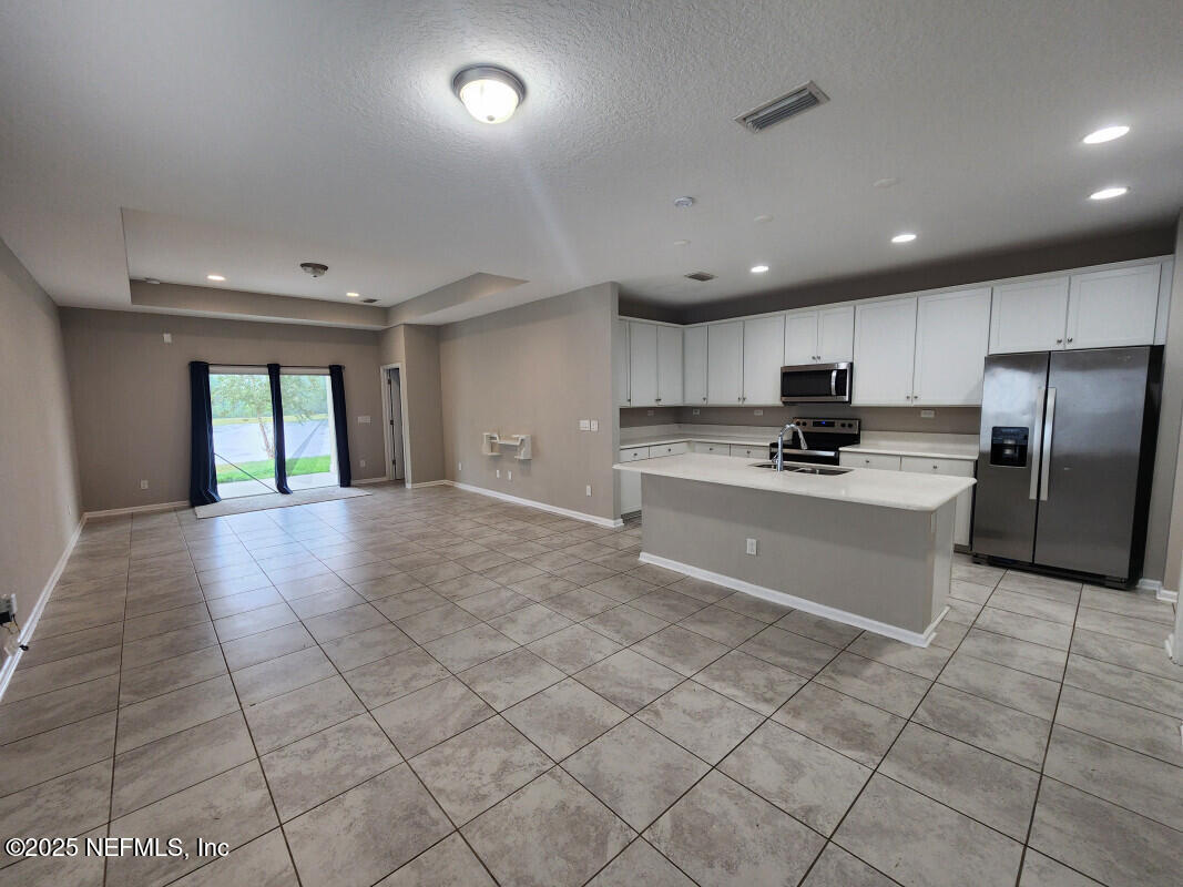 855 Sycamore Way Orange Park, FL 32073 - Photo 14 of 43 a large kitchen with stainless steel appliances granite countertop a stove a sink and a refrigerator