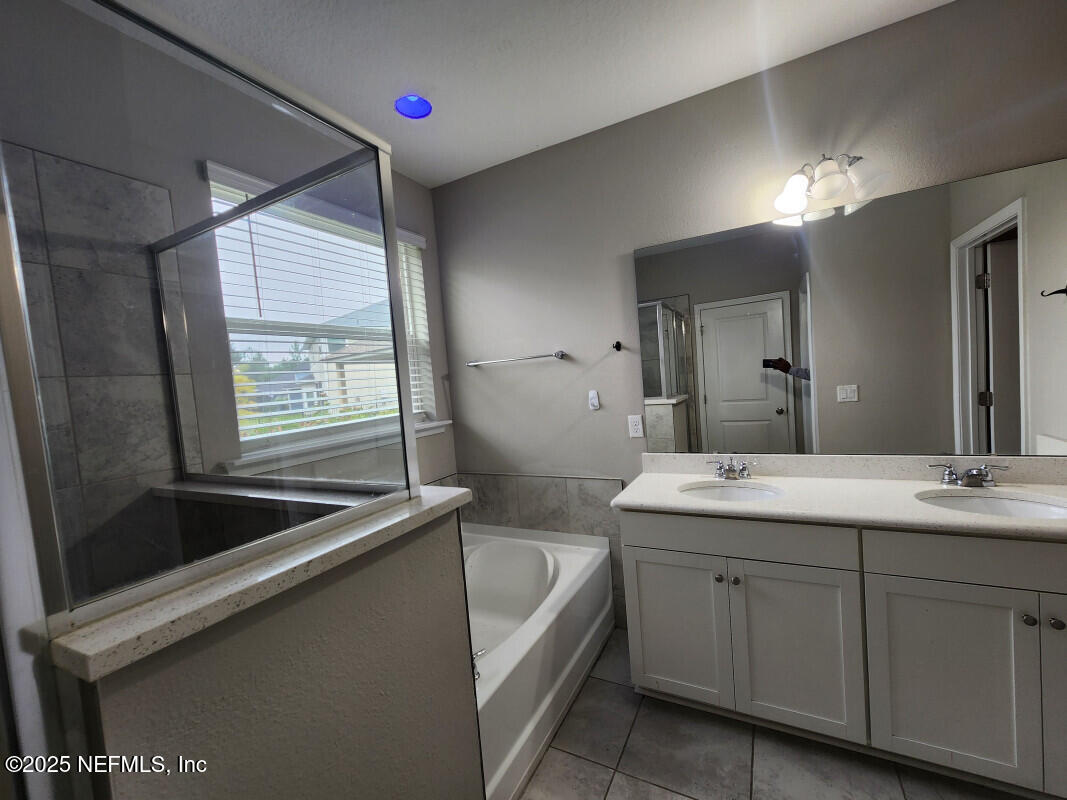 855 Sycamore Way Orange Park, FL 32073 - Photo 21 of 43 a spacious bathroom with a granite countertop sink and a mirror