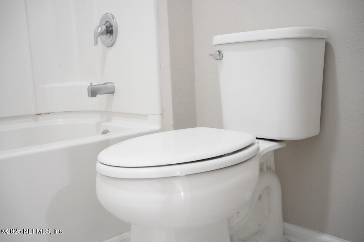 855 Sycamore Way Orange Park, FL 32073 - Photo 26 of 43 a bathroom with a white toilet and a tub
