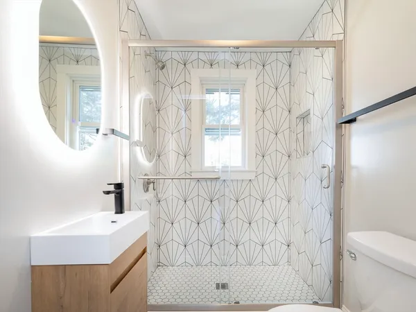 a bathroom with a shower curtain a sink and a mirror