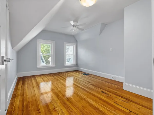 wooden floor in a room next to a window