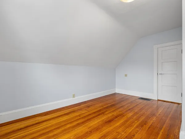 a view of room with wooden floor