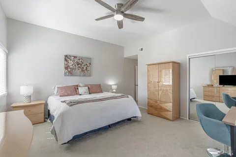 a bedroom with a bed couch and window