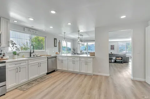 a large white kitchen with a large window