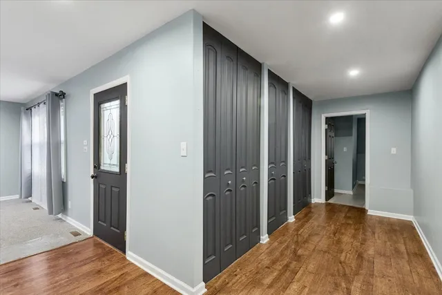 a view of hallway with wooden floor