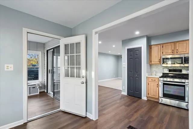 a kitchen with stainless steel appliances granite countertop a refrigerator and a stove top oven