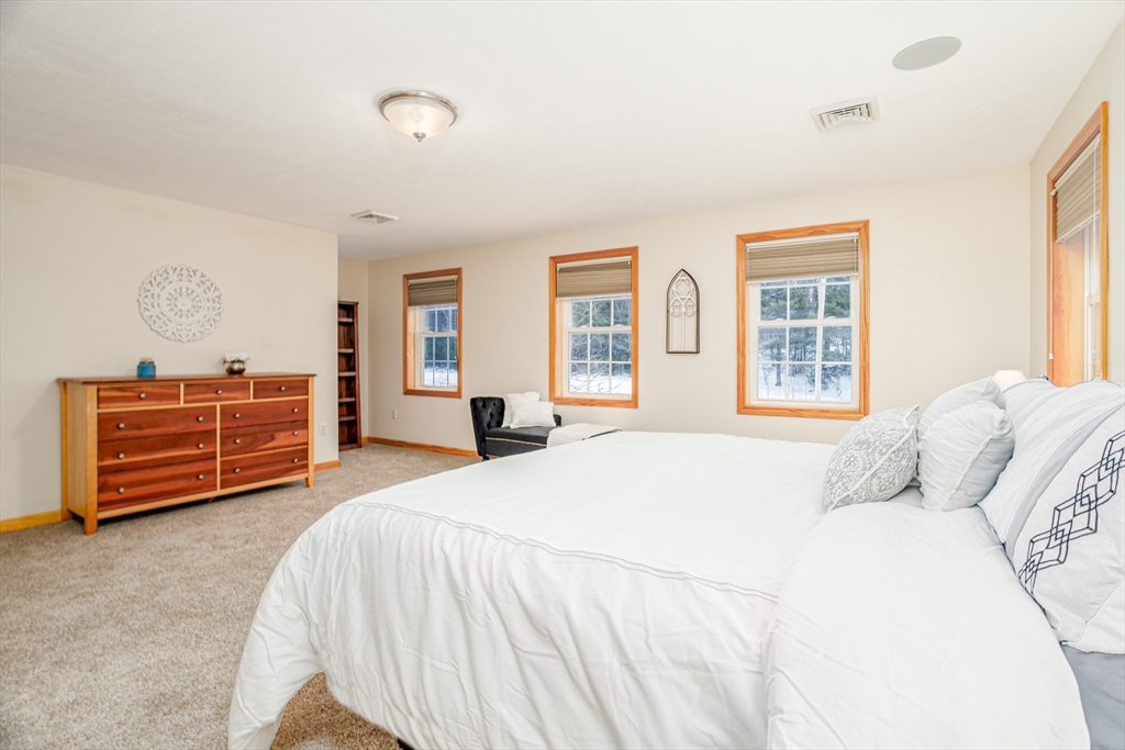 326 Matthews Street Gardner, MA 01440 - Photo 23 of 42 a bedroom with a bed and dresser with mirror