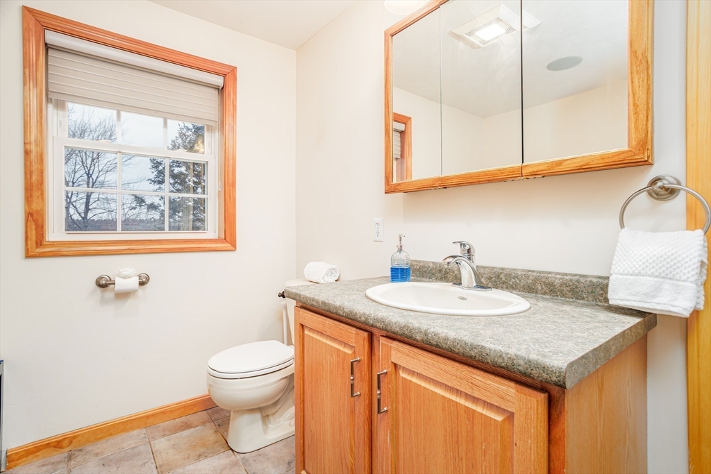 326 Matthews Street Gardner, MA 01440 - Photo 26 of 42 a bathroom with a granite countertop sink and a toilet