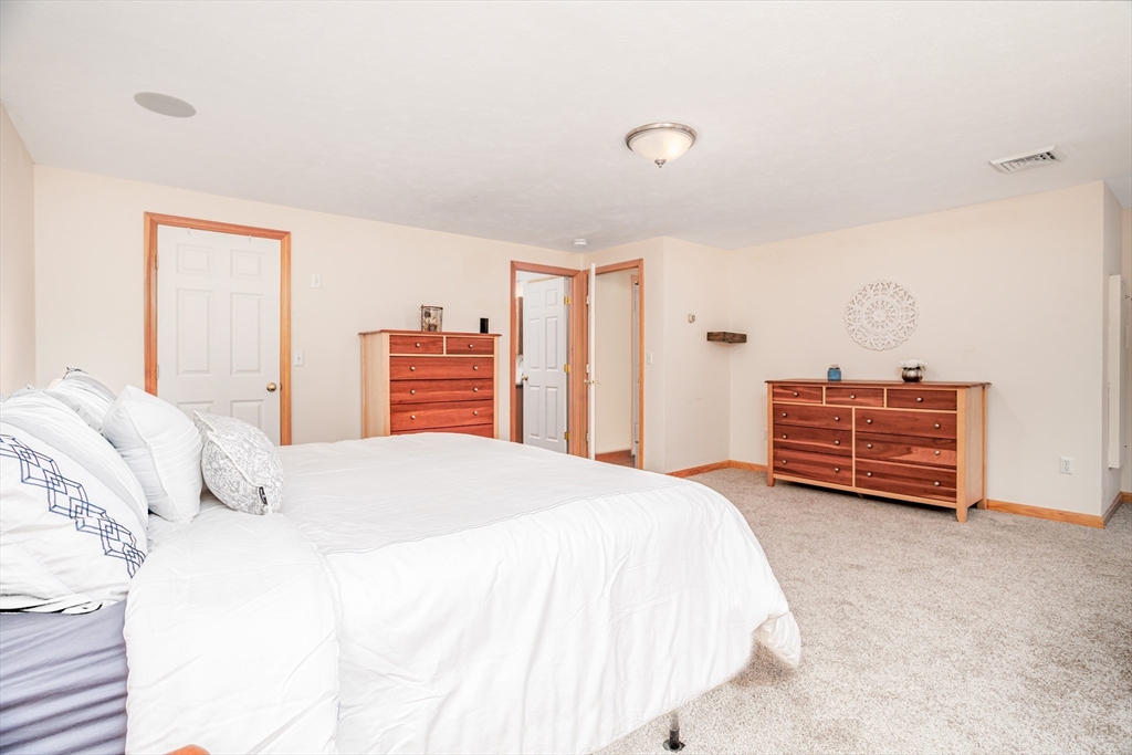 326 Matthews Street Gardner, MA 01440 - Photo 28 of 42 a bedroom with a bed and dresser with wooden floor