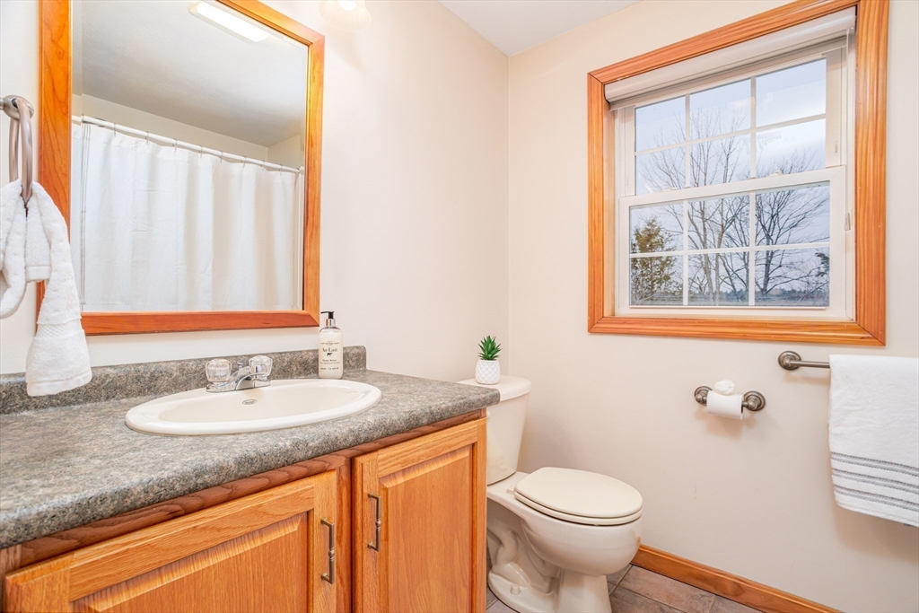 326 Matthews Street Gardner, MA 01440 - Photo 29 of 42 a bathroom with a granite countertop toilet sink and mirror
