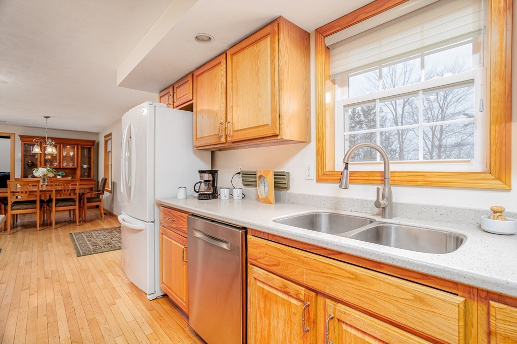 326 Matthews Street Gardner, MA 01440 - Photo 8 of 42 a kitchen with stainless steel appliances granite countertop a sink and a wooden cabinets